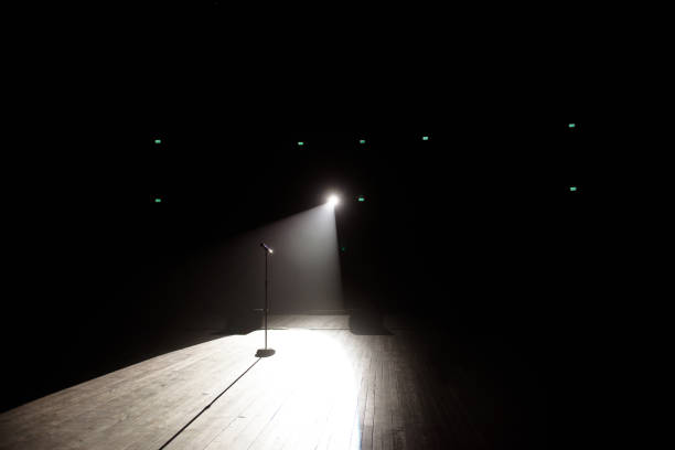 istock Microphone in a smoke on a dark background in the beam of light. 1211966610