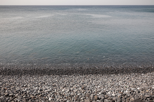 Calm water at a stony beach at the southern part of Tenerife