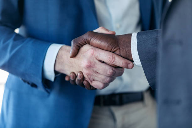 istock Close-up view of business partner handshaking process. 1211967035