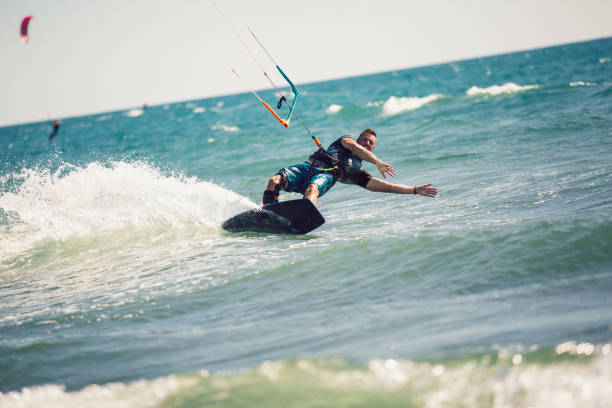 istock Professional kiter makes the difficult trick on a beautiful background. 1211967854