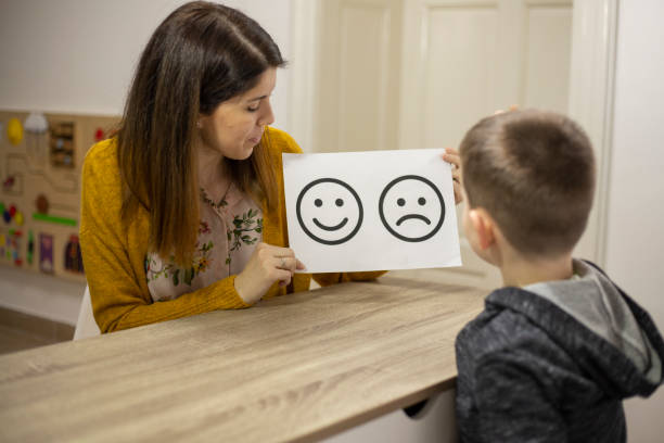 istock Psychologist showing picture to boy 1211970176