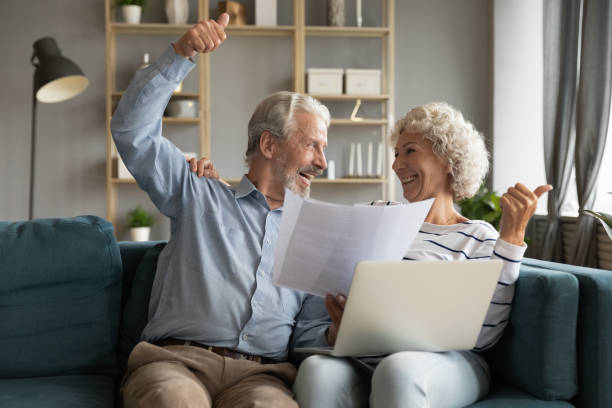 istock Happy elderly spouses clients excited with easy online payment 1211971814