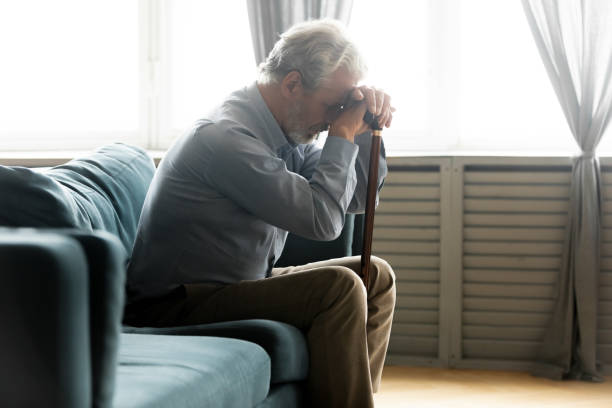 istock Unhappy old man with cane feel lonely at home 1211971850