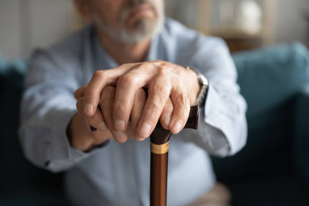 istock Close up of lonely old man with cane missing 1211971856