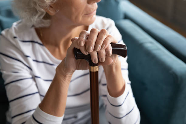 istock Upset old woman with cane mourning thinking at home 1211971887
