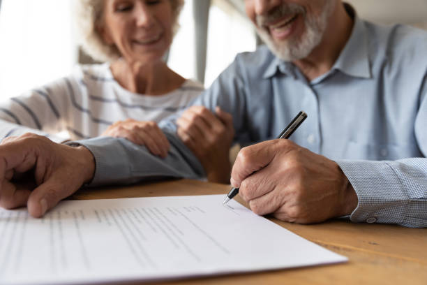 istock Old couple make agreement sign insurance contract 1211971898