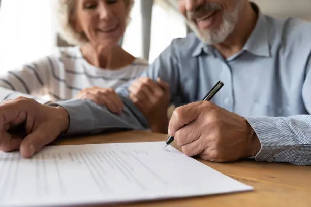 Photo of Old couple make agreement sign insurance contract