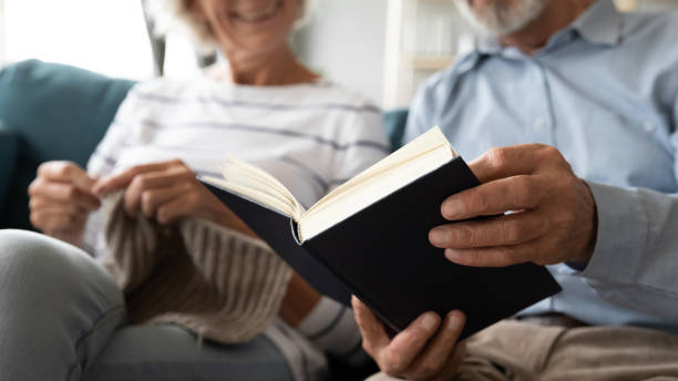 Happy retired couple have fun with hobbies at home