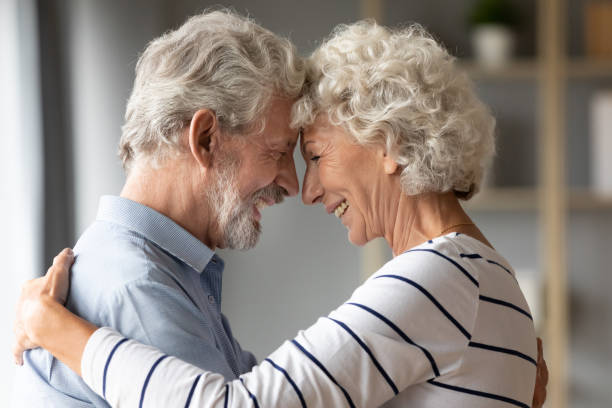 istock Smiling mature husband and wife share romantic moment together 1211971908