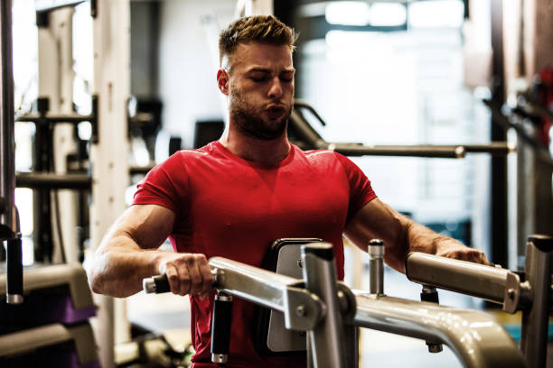 istock Muscular male athlete focusing on breathing while doing a strength training exercise 1211972737