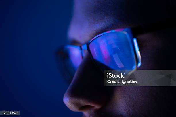 Closeup Of A Part Of A Male Human Face With Glasses In Neon Light Stock Photo - Download Image Now