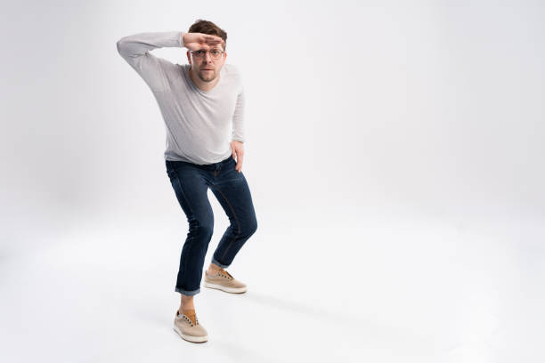 istock Funny man in casual is having some fun. He is posing and dancing. Isolated on white background. 1211974242