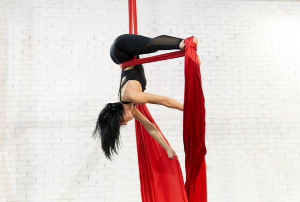 istock beautiful woman doing aerial dance with fabrics 1211975003