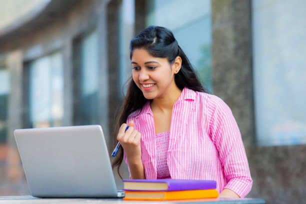 Student Sitting On Campus stock photo Studying, University, Student, University Student, Indian Ethnicity, good grades stock pictures, royalty-free photos & images