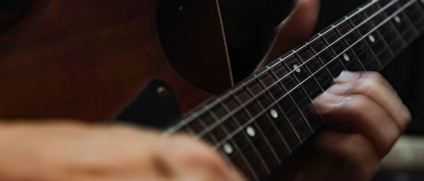 istock closeup of playing electric guitar 1211977805