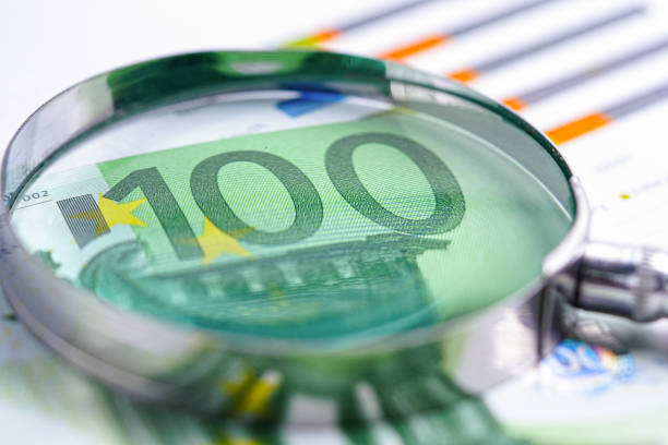 magnifying glass with Euro banknotes money on chart graph paper. Financial development, Banking Account, Statistics, Investment Analytic research data economy, trading, office reporting Business company meeting concept.
