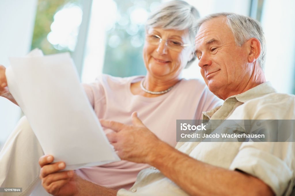 Happy senior couple planning for retirement  60-64 Years Stock Photo