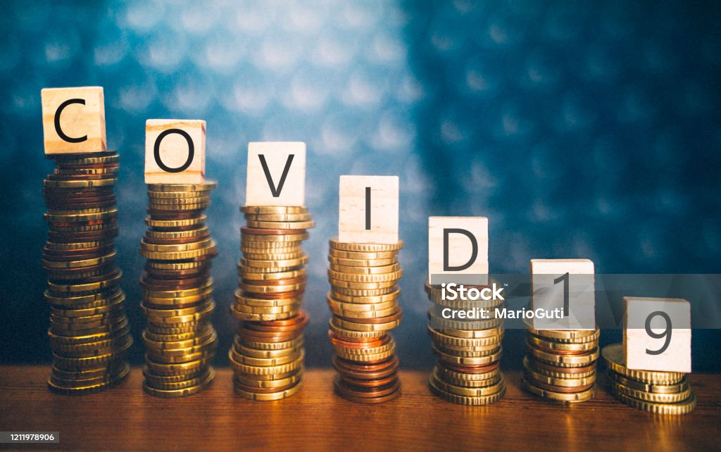 COVID-19 and economy recession Diminishing stacks of coins with COVID-19 (Coronavirus disease) written on them Coronavirus Stock Photo