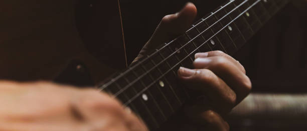 istock closeup of playing electric guitar 1211979056