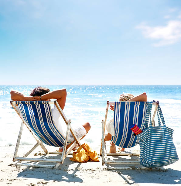 istock View of a couple sitting on deck chairs enjoying vacation 121197923