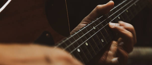 istock closeup of playing electric guitar 1211979268