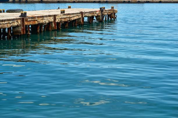 old concrete sea berth or pier for boats and yachts and calm sea water surface