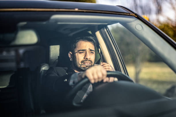 istock Man Making Effort to See The Road. 1211980169