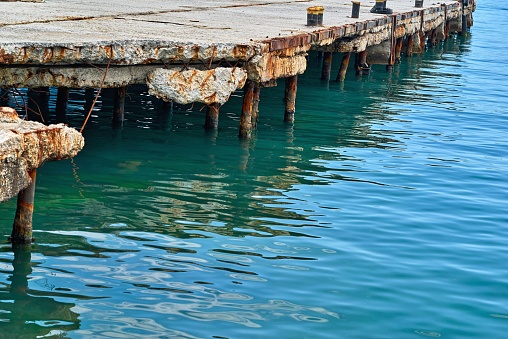 old concrete sea berth or pier closeup for boats and yachts and calm sea water surface