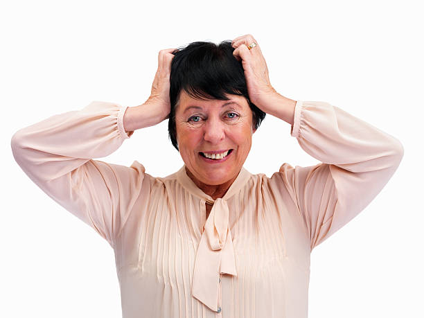 istock Frustrated senior woman grabbing her head over white 121198063