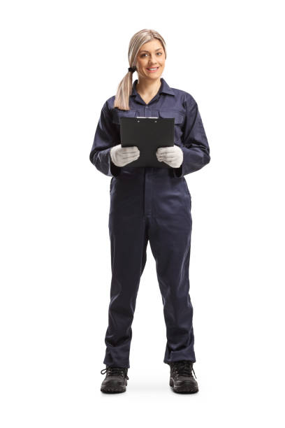istock Female worker in an overall uniform holding a clipboard 1211981371