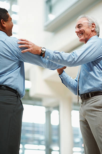 istock Mature business man congratulating his colleague 121198432