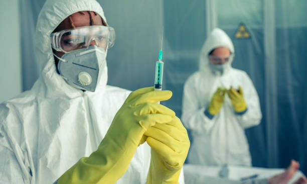 Doctor preparing syringe with virus vaccine Doctor preparing syringe with virus vaccine to treat a patient ebola stock pictures, royalty-free photos & images