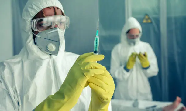 Photo of Doctor preparing syringe with virus vaccine