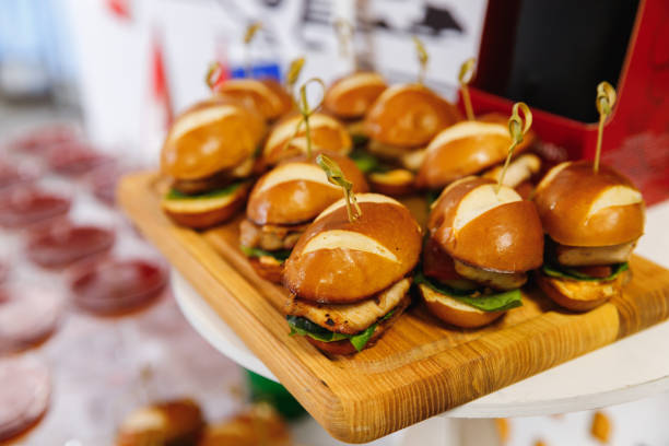 istock Mini Chicken Burger on wooden chopping board with blur background. 1211987382
