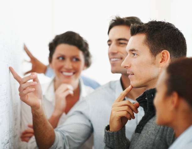 istock Business people looking at a chart put on the wall 121198774