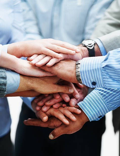 Closeup of a business people with hands together Agreement - Closeup of a business colleagues with their hands together loyalty photos stock pictures, royalty-free photos & images