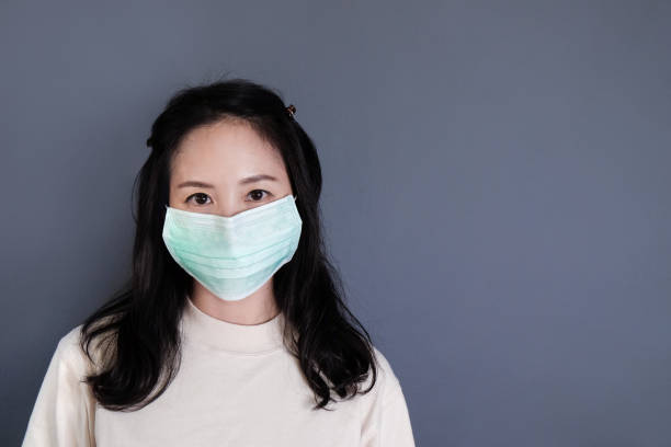 istock Girl with mask to protect her from virus or pollution 1211989259