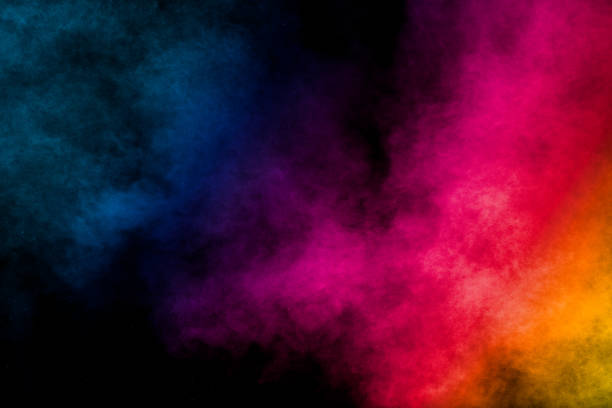 istock Multi colored particles explosion on black background.Colorful dust splash on dark background. 1211989303