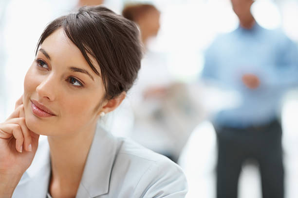 istock Pretty young business female thinking about something 121199142