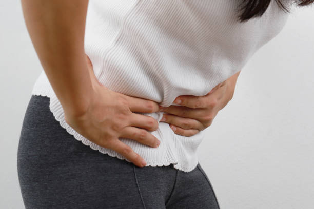 istock Woman with a stomach ache 1211992548