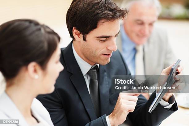 Business Man Making Calculations During A Meeting Stock Photo - Download Image Now - Active Seniors, Adult, Brown Hair