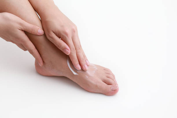 istock Woman moisturizing legs 1211993698