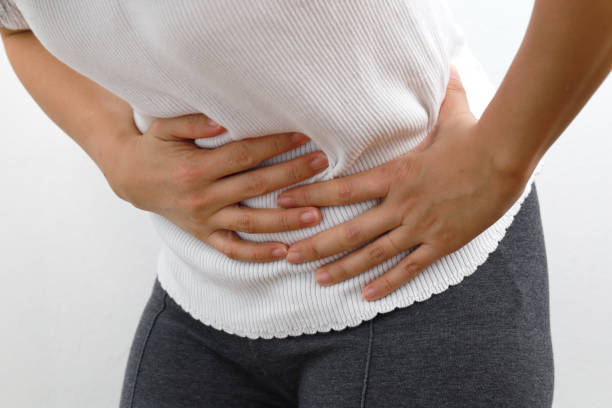 istock Woman with a stomach ache 1211993796