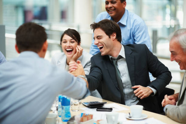 istock Happy man joining hands in unity with colleague at meeting 121199418
