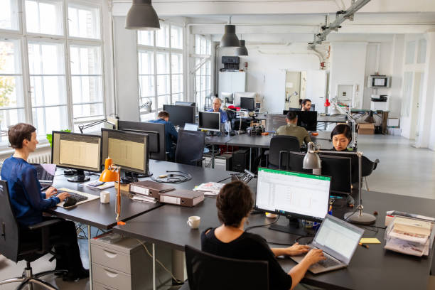 istock Business people working in an open plan office 1211994307