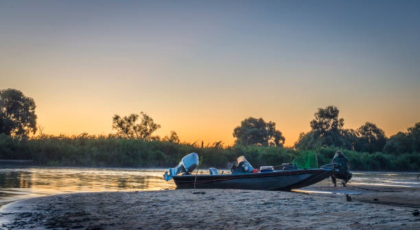istock Boat on the background of the setting sun. 1211994450