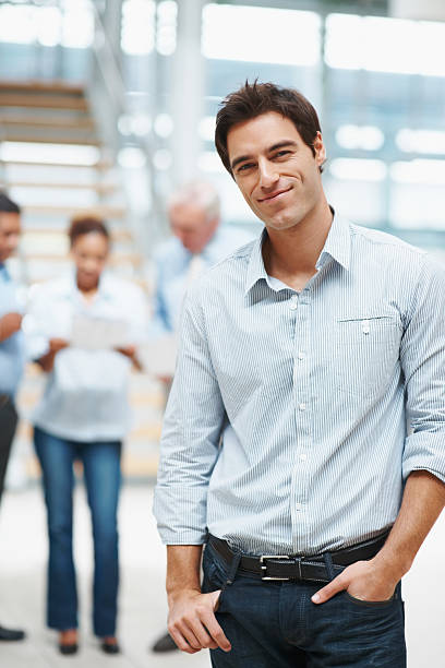 istock Smart executive with colleagues in discussion at the background 121199493