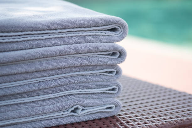 istock Grey towel on relaxing pool bed beside swimming pool at hotel. 1211995963