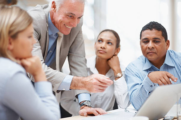 istock Business manager discussing a new project on laptop with team 121199612