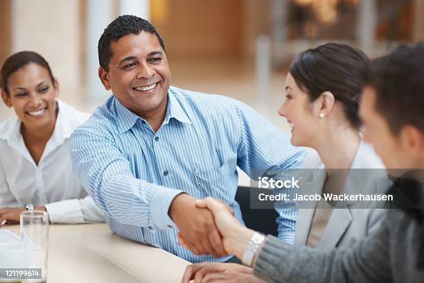 Men Shaking Hands At A Conference Table Stock Photo - Download Image Now - Bridging The Gap, Agreement, Business